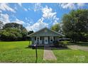 Quaint single-story home with a well-kept lawn and cozy front porch at 227 Nassau Pl, Mount Holly, NC 28120