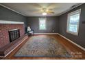 Inviting living room with brick fireplace and hardwood floors at 227 Nassau Pl, Mount Holly, NC 28120