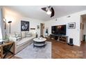 Inviting living room with a comfortable sofa and large TV at 2620 Park Rd # F, Charlotte, NC 28209