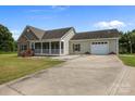 Charming home with stone accents, covered porch, and an attached two-car garage on a sunny day at 307 Nc Hwy 49 S Hwy, Richfield, NC 28137