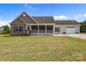 Charming home with stone accents, covered porch, and well-maintained lawn on a sunny day at 307 Nc Hwy 49 S Hwy, Richfield, NC 28137