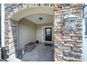Welcoming front porch with stone archway, stylish decor, and a cozy entrance at 329 Wave Crest Dr, Tega Cay, SC 29708