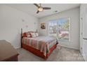 Bright bedroom featuring a window, ceiling fan, carpet floors and a decorative bed at 4022 Perth Rd, Indian Land, SC 29707