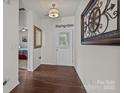 Bright entryway showcasing wood floors, decorative wall art, and a view into an adjacent room at 4022 Perth Rd, Indian Land, SC 29707