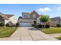 Two-story home with a 2 car garage, manicured lawn and landscaping plus a large concrete driveway at 4022 Perth Rd, Indian Land, SC 29707