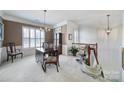 Traditional dining area with plantation shutters, chandelier, and elegant furnishings at 44424 Oriole Dr # 200, Indian Land, SC 29707