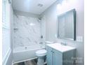 Updated bathroom featuring white tile and new fixtures at 509 8Th Avenue Ext, Cramerton, NC 28032