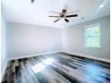 This bedroom features a ceiling fan, large window and modern flooring at 509 8Th Avenue Ext, Cramerton, NC 28032