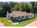 Aerial view of a single-story home with a sprawling lawn and mature trees in a peaceful setting at 509 8Th Avenue Ext, Cramerton, NC 28032
