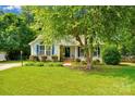 Well-maintained home with lush front lawn, complemented by mature trees providing ample shade at 666 Tryon Pl, Gastonia, NC 28054