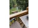 View of a wood deck with outdoor seating overlooking a lush waterfront and private boat dock at 729 Victoria Ln, Hickory, NC 28601