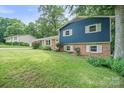 Beautiful blue home on a lush green lawn surrounded by mature trees in a neighborhood at 742 Stonecrest Dr, Statesville, NC 28625