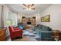 Cozy living room featuring hardwood floors, a ceiling fan, and comfortable seating at 742 Stonecrest Dr, Statesville, NC 28625