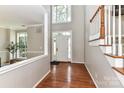 Bright foyer with a high ceiling, hardwood floors, and natural light from the front door at 9029 Torrence Crossing Dr, Huntersville, NC 28078