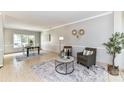 Comfortable living room with neutral walls, tile flooring, and a view into the dining area at 9029 Torrence Crossing Dr, Huntersville, NC 28078