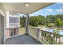 Relaxing view from a private balcony overlooking the community pool and lush greenery at 9271 Meadow Vista Rd, Charlotte, NC 28213
