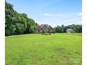 Charming two-story home with landscaped yard and lush green lawn in a peaceful, verdant setting at 1011 Duntov Dr, Monroe, NC 28110