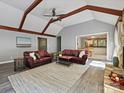 Spacious living room featuring vaulted ceilings with wooden beams, grey walls, and a fireplace at 14019 Fountain Ln, Charlotte, NC 28278