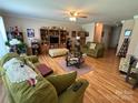 Cozy living room with hardwood floors, ceiling fan, and comfortable seating at 1412 Cold Creek Pl, Huntersville, NC 28078