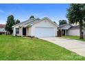 Well-kept single-Gathering home featuring green lawn, attached two-car garage, and neutral siding at 1628 Sandpiper Dr, Rock Hill, SC 29732