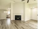 Open-concept living room with fireplace and luxury vinyl plank flooring at 1628 Sandpiper Dr, Rock Hill, SC 29732