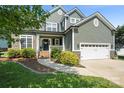 Charming two-story home featuring stone accents, a well-manicured lawn, and a two-car garage at 1677 Shetland Ln, Rock Hill, SC 29730