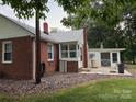 Brick home featuring a back porch and a spacious yard, perfect for outdoor relaxation and entertaining at 180 Tower Rd, Troy, NC 27371