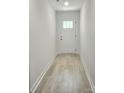 Bright entryway with wood-look flooring and a white front door with glass inserts at 2137 Barrowcliffe Dr # 49, Concord, NC 28027