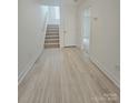 Hallway features hard surface flooring, neutral paint and provides access to various rooms in the home at 2137 Barrowcliffe Dr # 49, Concord, NC 28027