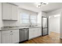 Newly remodeled kitchen boasts stainless steel appliances, granite counters, and white cabinetry at 2488 Catawba Church Rd, Rock Hill, SC 29730
