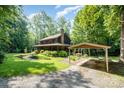 Beautiful exterior of a home with a covered parking area and mature trees at 2615 Highway 557 None, Clover, SC 29710