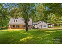 Charming home with a metal roof, a covered porch, and a large yard at 265 River Run Rd, Statesville, NC 28625