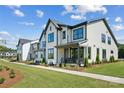 Attractive new construction townhomes with inviting exteriors, manicured lawns, and sidewalks at 327 Ardmore Dr, Belmont, NC 28012