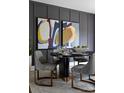 Dining room with modern decor including abstract art, stylish gray chairs, and a striking black table at 4114 Lattistep Ln, Charlotte, NC 28269