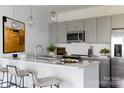 Beautiful kitchen featuring stainless steel appliances, modern gray cabinets, pendant lighting, and a spacious island at 4114 Lattistep Ln, Charlotte, NC 28269