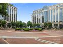 Low angle exterior shot of large building with water fountain and manicured landscaping at 4625 Piedmont Row Dr, Charlotte, NC 28210