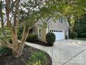 Spacious two-car garage with a white door and a well-manicured lawn at 5024 Ardenwoods Dr, Charlotte, NC 28215