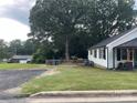 Side view of home with lush, green yard and mature trees, offering lots of privacy at 508 E Rice St, Landis, NC 28088