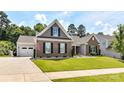 A well-maintained home showcasing a brick exterior, attached garage, lush green lawn, and inviting curb appeal at 5129 Devonshire Rd, Denver, NC 28037