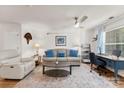 Bright living room with hardwood floors, a cozy fireplace, and a dedicated workspace at 9977 Reindeer Way Ln, Charlotte, NC 28216
