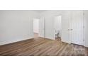 This bright bedroom has light vinyl flooring and crisp white walls and trim at 1108 4Th St, Statesville, NC 28677