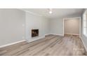 Spacious living room featuring wood floors, a brick fireplace, and neutral paint at 1138 Laurel St, Salisbury, NC 28144