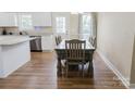 Sunlit dining area featuring hardwood floors, a table that seats six, and white shaker cabinets at 118 Cypress Acres Ln, Statesville, NC 28625