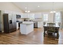 Modern kitchen with white cabinetry, granite countertops, stainless steel appliances, and a dining area at 118 Cypress Acres Ln, Statesville, NC 28625