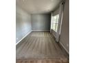 This cozy bedroom has a big window with curtains and carpeted floors at 1411 Cottage Green Dr # 218, Monroe, NC 28112