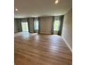 An expansive living room featuring hardwood floors, natural light and recessed lighting at 1411 Cottage Green Dr # 218, Monroe, NC 28112