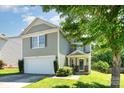 Attractive two-story home features attached garage, well-kept lawn, and charming front entrance with stone accents at 1432 Matthew Allen Cir, Kannapolis, NC 28081