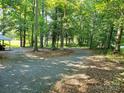 Spacious and secluded gravel yard surrounded by mature trees with plenty of space for parking at 16711 Indian Mound Rd, Albemarle, NC 28001