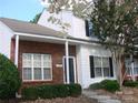 Charming brick and white two-story townhouse with a well-maintained front yard and welcoming entrance at 1814 Birch Heights Ct, Charlotte, NC 28213