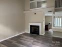 Spacious living room with hardwood flooring and a cozy fireplace, creating an inviting atmosphere at 1814 Birch Heights Ct, Charlotte, NC 28213